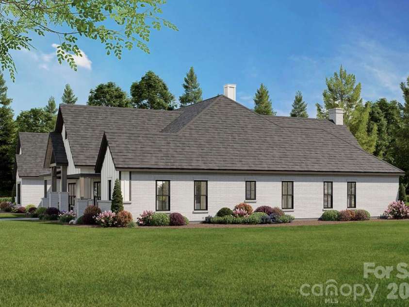 Lot 4 Country Estates Drive, Waxhaw, NC 28173.  MLS# CAR4278303, YatesRealty ID 4510. Expansive windows offer abundant natural light, while the landscaped yard and surrounding trees provide privacy and a serene, natural backdrop.