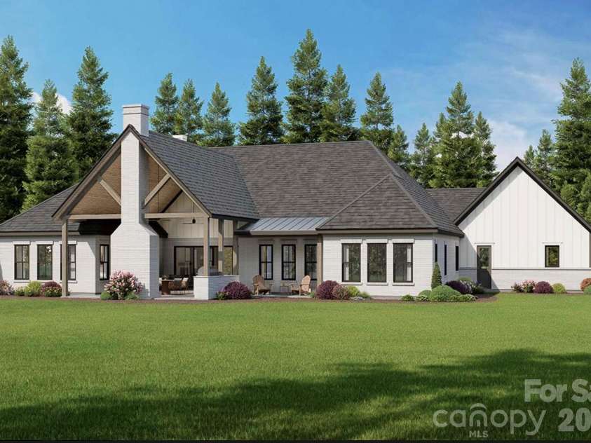 Lot 4 Country Estates Drive, Waxhaw, NC 28173.  MLS# CAR4278303, YatesRealty ID 4510. Spacious covered patio with exposed timber trusses and a brick fireplace, perfect for outdoor living and entertaining. 