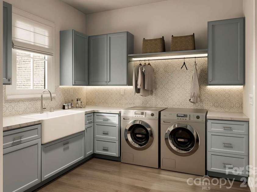 Lot 4 Country Estates Drive, Waxhaw, NC 28173.  MLS# CAR4278303, YatesRealty ID 4510. This beautifully appointed laundry room combines charm and utility with soft blue cabinetry, patterned backsplash tile, and warm wood flooring.
