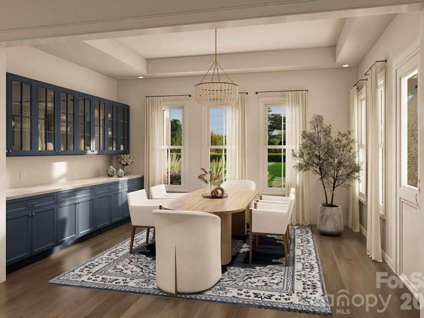 Lot 4 Country Estates Drive, Waxhaw, NC 28173.  MLS# CAR4278303, YatesRealty ID 4510. This elegant dining room offers a perfect balance of sophistication and warmth. The space features full-height navy built-in cabinetry with glass-front upper doors.