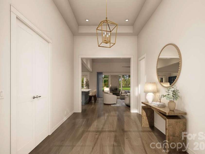Lot 4 Country Estates Drive, Waxhaw, NC 28173.  MLS# CAR4278303, YatesRealty ID 4510. This elegant foyer sets a refined tone with its high tray ceiling, soft neutral palette, and sleek wood floors that flow seamlessly into the main living area.