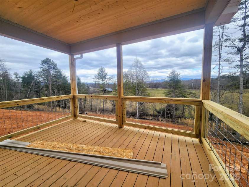 59 Eller Ford Road, Weaverville, NC 28787.  MLS# CAR4229304, YatesRealty ID 4513. Covered back porch w/ long range pastoral and Mtn. Views
