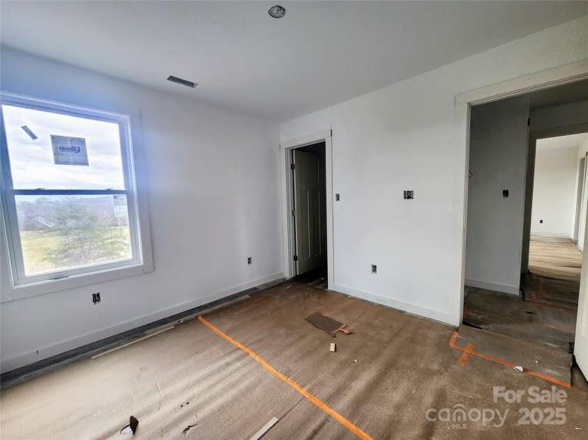 59 Eller Ford Road, Weaverville, NC 28787.  MLS# CAR4229304, YatesRealty ID 4513. Guest Bedroom that offers a large walk in closet.