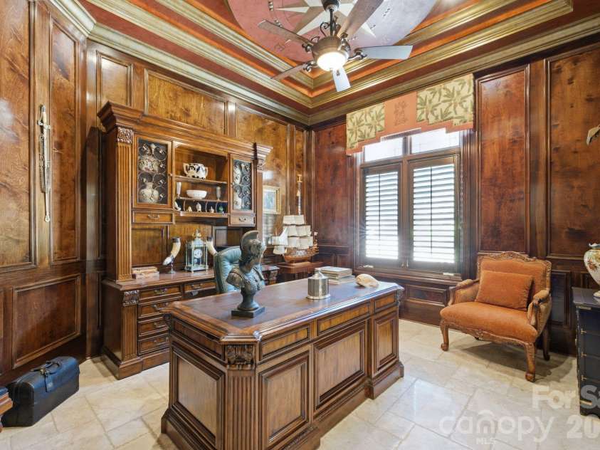 178 Mariner Pointe Lane, Mooresville, NC 28117.  MLS# CAR4414356, YatesRealty ID 45154. Rich wood-paneled private office creates a distinguished work from home setting.