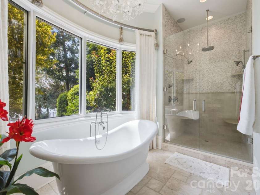 178 Mariner Pointe Lane, Mooresville, NC 28117.  MLS# CAR4414356, YatesRealty ID 45154. Spa-inspired primary bath features a freestanding soaking tub positioned beside oversized windows.