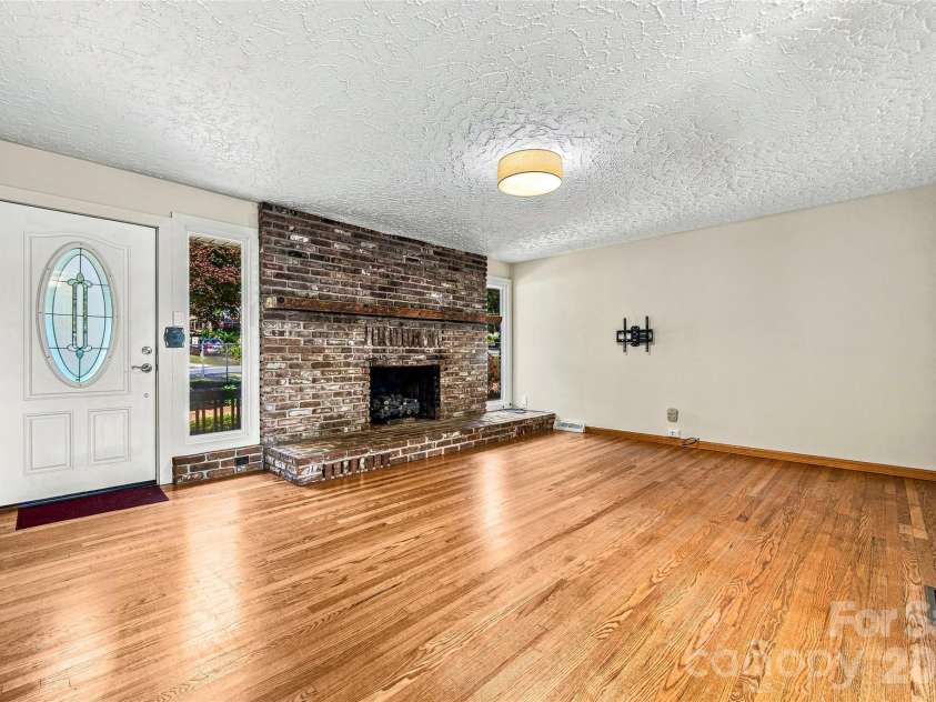 708 Loop Road, Hendersonville, NC 28792.  MLS# CAR4415625, YatesRealty ID 45204. Inviting brick fireplace and hardwood floors