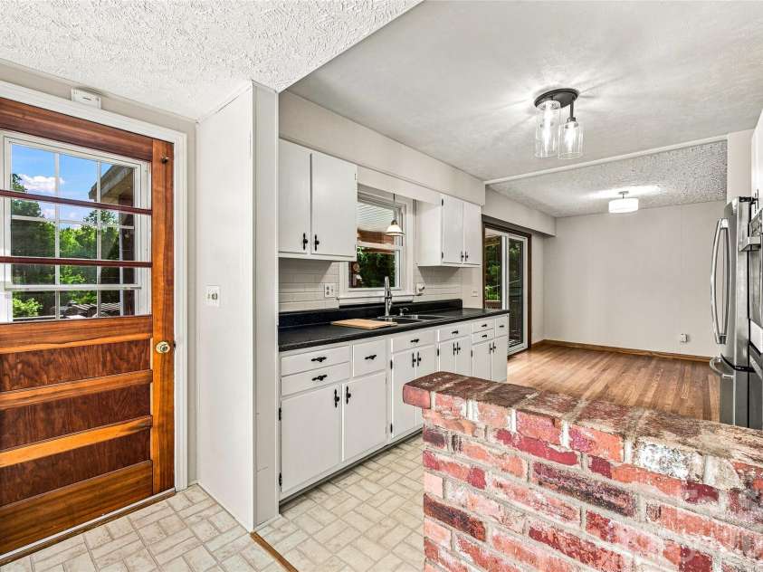 708 Loop Road, Hendersonville, NC 28792.  MLS# CAR4415625, YatesRealty ID 45204. Kitchen and door to deck for entertaining