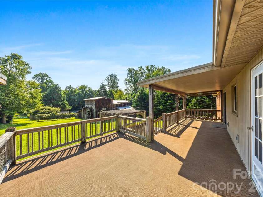 708 Loop Road, Hendersonville, NC 28792.  MLS# CAR4415625, YatesRealty ID 45204. Large deck overlooking private yard