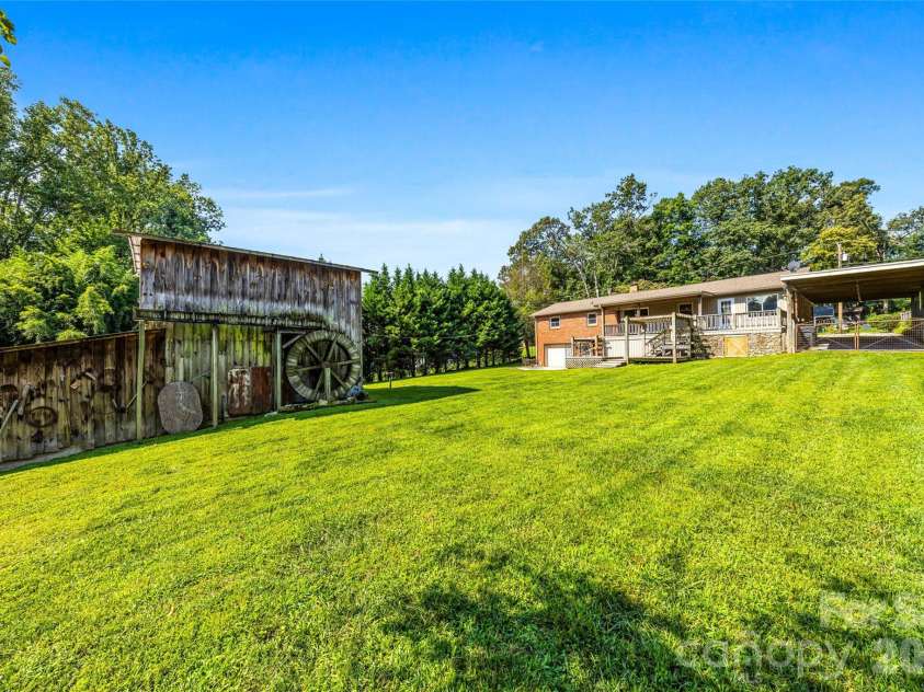 708 Loop Road, Hendersonville, NC 28792.  MLS# CAR4415625, YatesRealty ID 45204. Spacious yard and large barn/workshop
