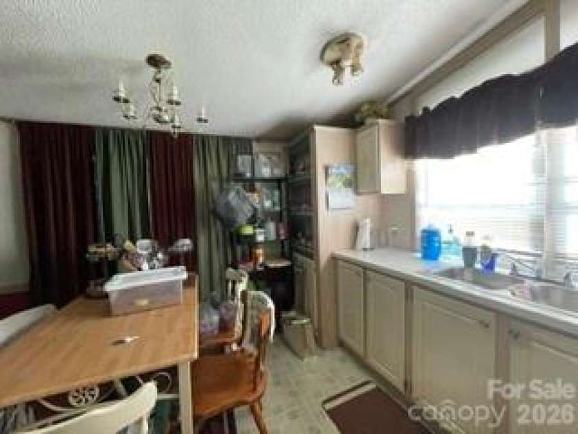 1098 Macedonia Road, Gaffney, SC 29341.  MLS# CAR4415994, YatesRealty ID 45218. Kitchen / sliding doors to deck behind curtains