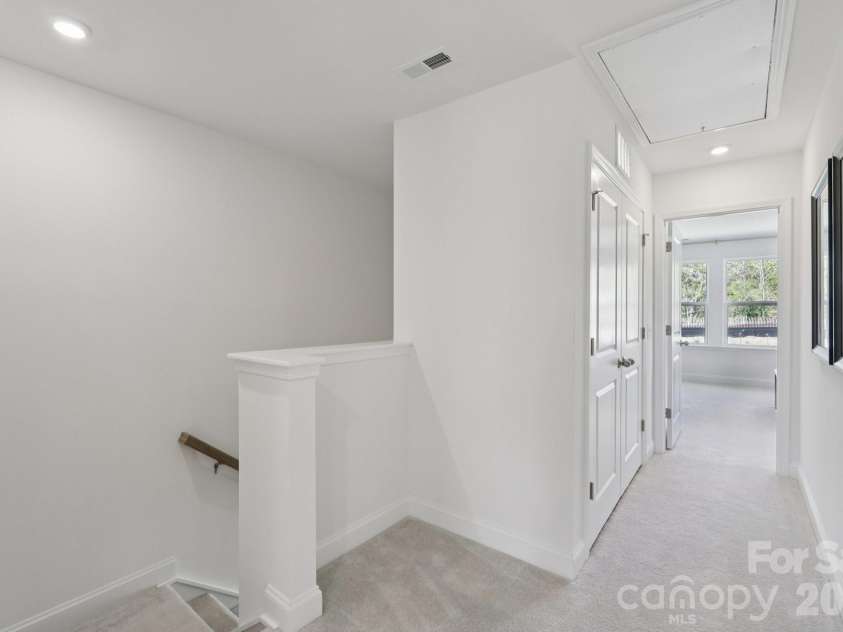 7607 Ethora Way, Charlotte, NC 28216.  MLS# CAR4416061, YatesRealty ID 45219. Second floor hallway and laundry-Representation picture-not actual home