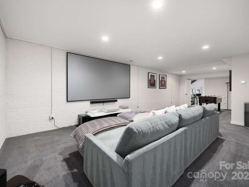 22 Innsbrook Road, Asheville, NC 28804.  MLS# CAR4215149, YatesRealty ID 4523. 557 square foot lower level media/game room with projection screen television.