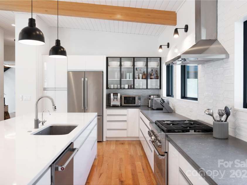22 Innsbrook Road, Asheville, NC 28804.  MLS# CAR4215149, YatesRealty ID 4523. Sleek UltraCraft Cabinetry throughout the kitchen with quartz and concrete countertops and Thermadore appliances.