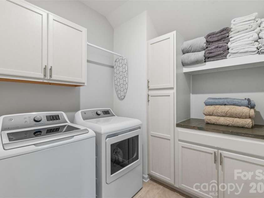 6440 Ancient Way, Fort Mill, SC 29707.  MLS# CAR4413430, YatesRealty ID 45254. A dedicated laundry room equipped with custom built-in cabinets and continuous countertop space to make folding and sorting effortlessly organized.