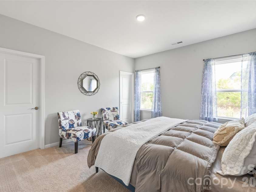 6440 Ancient Way, Fort Mill, SC 29707.  MLS# CAR4413430, YatesRealty ID 45254. A spacious bedroom featuring a generous walk-in closet and direct access to a shared full bathroom.