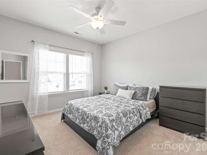 6440 Ancient Way, Fort Mill, SC 29707.  MLS# CAR4413430, YatesRealty ID 45254. A spacious third bedroom offering a generous walk-in closet and seamless access to a shared Jack-and-Jill bathroom.