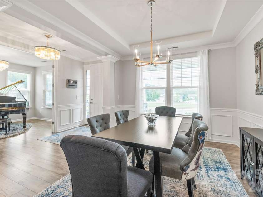 6440 Ancient Way, Fort Mill, SC 29707.  MLS# CAR4413430, YatesRealty ID 45254. Across the hall, the elegant dining room features refined trey ceilings, detailed trimwork, and seamless LVP floors designed for memorable dinners and effortless hosting.