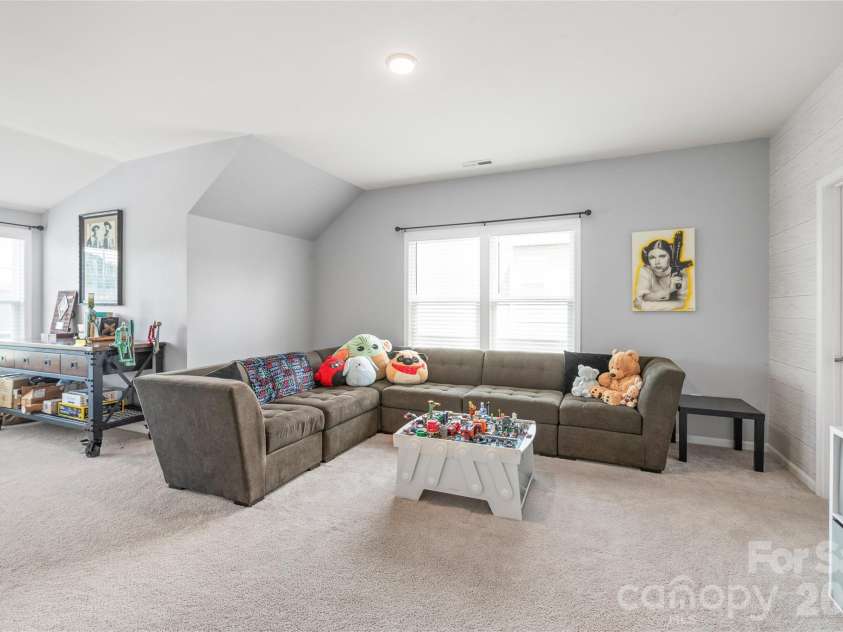 6440 Ancient Way, Fort Mill, SC 29707.  MLS# CAR4413430, YatesRealty ID 45254. An oversized bonus room that connects directly to a shared full bath with Bedroom 2 - ideal as a home theater or game room.