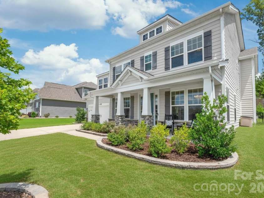 6440 Ancient Way, Fort Mill, SC 29707.  MLS# CAR4413430, YatesRealty ID 45254. Crafted for lasting durability and timeless beauty, the exterior features low-maintenance cement siding anchored by striking stone accent columns.
