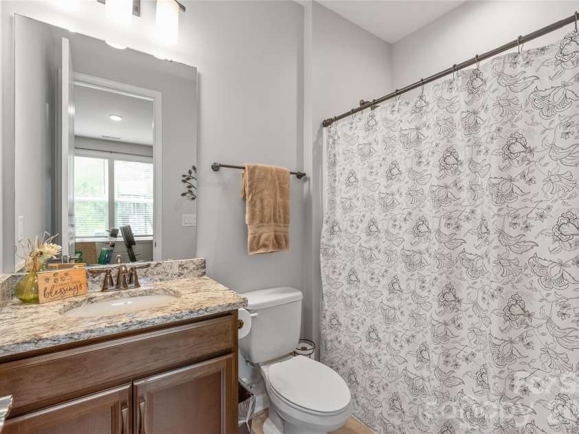 6440 Ancient Way, Fort Mill, SC 29707.  MLS# CAR4413430, YatesRealty ID 45254. Dedicated to the main-floor guest suite, this full bath is equipped with a clean, classic tub/shower combo for ultimate privacy and convenience.