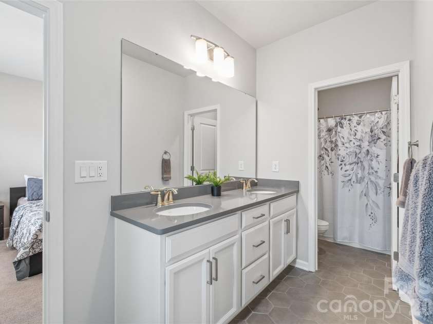 6440 Ancient Way, Fort Mill, SC 29707.  MLS# CAR4413430, YatesRealty ID 45254. Perfectly designed for shared living, this Jack-and-Jill bathroom features dual sinks and a separate wet room with the tub and toilet...making busy morning routines seamless for Bedrooms 3 and 4.