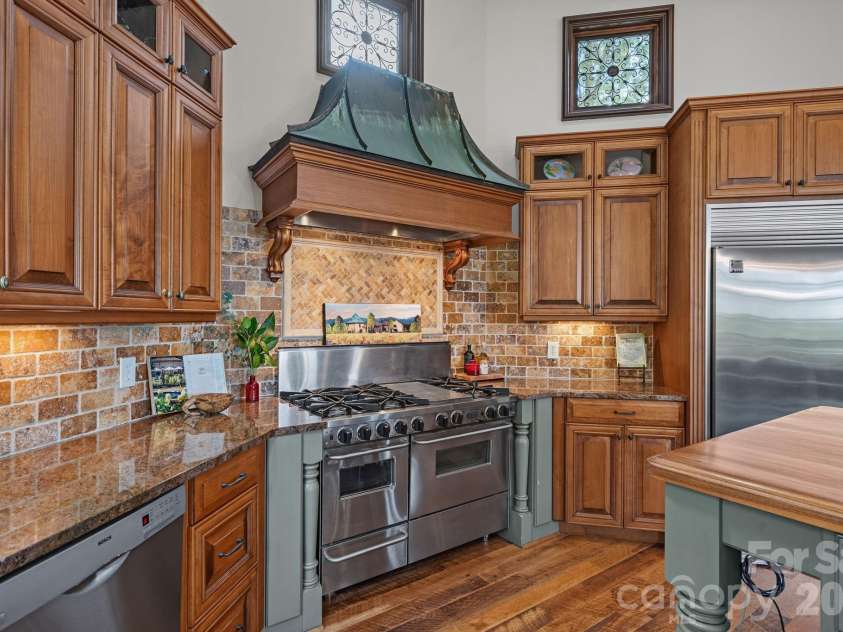 1807 Charden Road, Davidson, NC 28036.  MLS# CAR4410919, YatesRealty ID 45262. Custom patina-finished range hood.