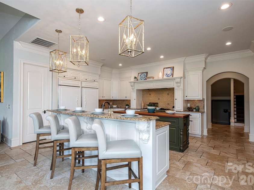 14905 Mcleary Circle, Charlotte, NC 28277.  MLS# CAR4410843, YatesRealty ID 45266. Features double side by side GE Monogram refrigerator, Thermador Professional 6 burner gas stove with grill, 2 DACOR warming drawers, Thermador double wall oven, Bosch Dishwasher, granite countertops and tile backspla
