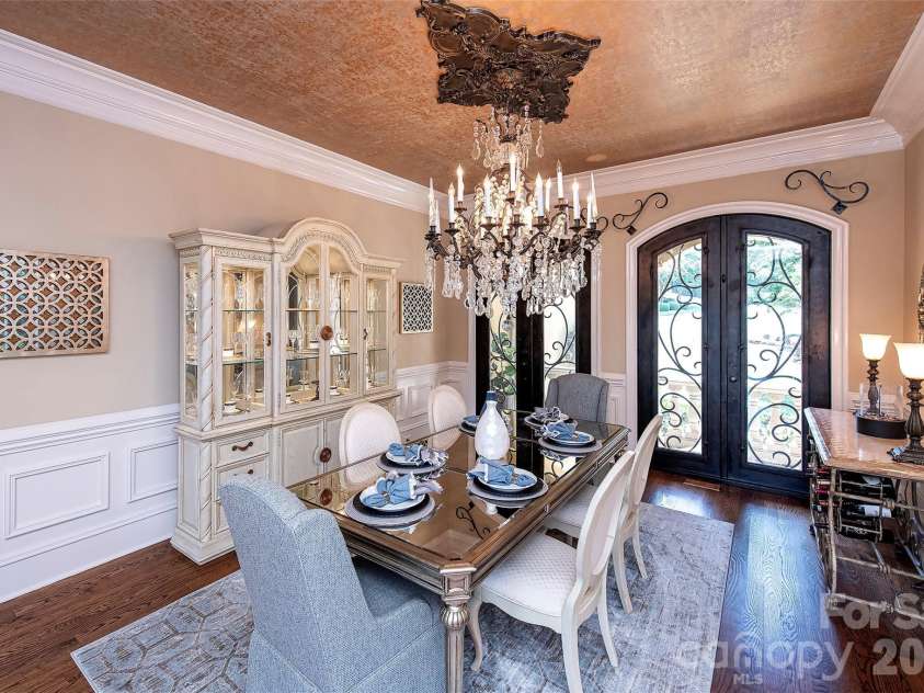 14905 Mcleary Circle, Charlotte, NC 28277.  MLS# CAR4410843, YatesRealty ID 45266. Rich architectural details include extensive custom millwork, arched doorways, vaulted and coffered ceilings, a striking stone fireplace and the luxurious crystal chandelier in the dining room.