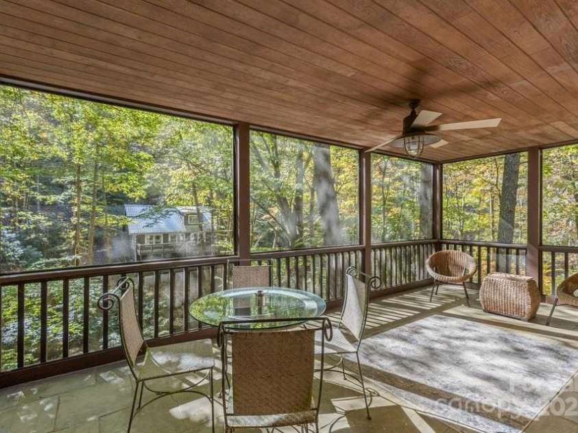 187 Big Buck Road, Highlands, NC 28741.  MLS# CAR4317414, YatesRealty ID 45286. Screened Porch of Primary Ensuite.  Access Lower-Level deck and stone patio.