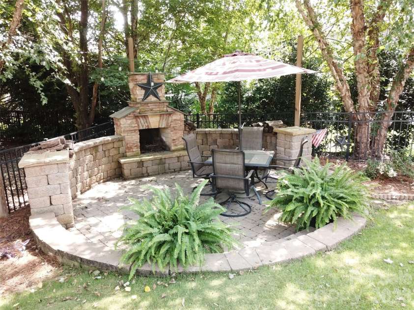 17228 Marbella Lane, Indian Land, SC 29707.  MLS# CAR4413011, YatesRealty ID 45302. Fireplace located in backyard.
