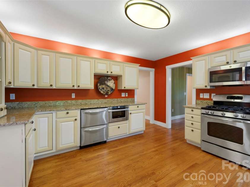 236 Holland Drive, Black Mountain, NC 28711.  MLS# CAR4412802, YatesRealty ID 45307. Abundant counter space, ample storage, and generous room to work make this kitchen both functional and inviting, with everything you need conveniently at your fingertips.