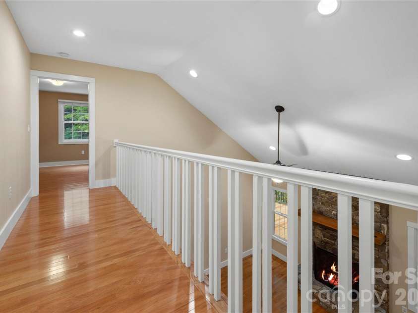 236 Holland Drive, Black Mountain, NC 28711.  MLS# CAR4412802, YatesRealty ID 45307. The spacious open cathedral ceiling creates an airy, welcoming atmosphere, featuring a beautiful walkway that leads to both upstairs bedrooms.