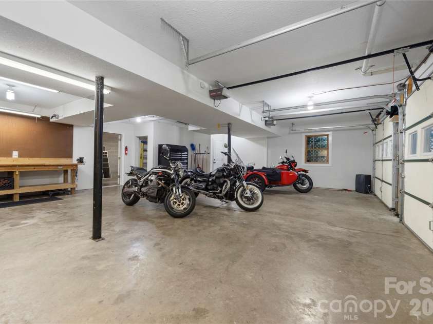 236 Holland Drive, Black Mountain, NC 28711.  MLS# CAR4412802, YatesRealty ID 45307. This oversized garage provides ample space for both your primary vehicles and recreational equipment, perfect for enjoying excursions in the mountains.