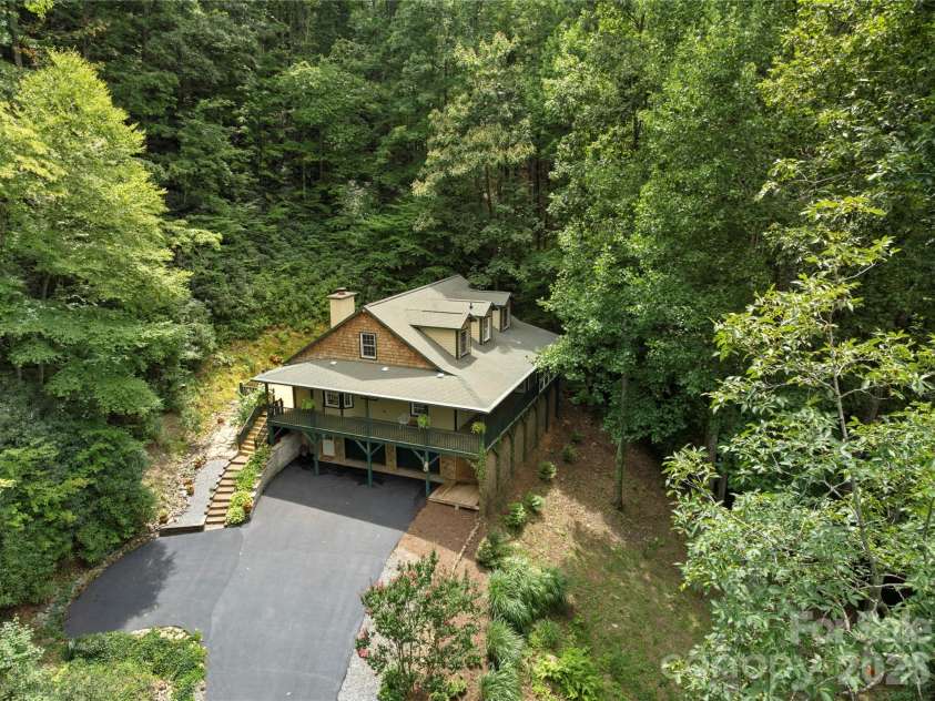 236 Holland Drive, Black Mountain, NC 28711.  MLS# CAR4412802, YatesRealty ID 45307. This property offers a peaceful, private setting nestled in nature while remaining just five minutes from the heart of downtown Black Mountain, where you can enjoy local restaurants, unique shops, live music venues,