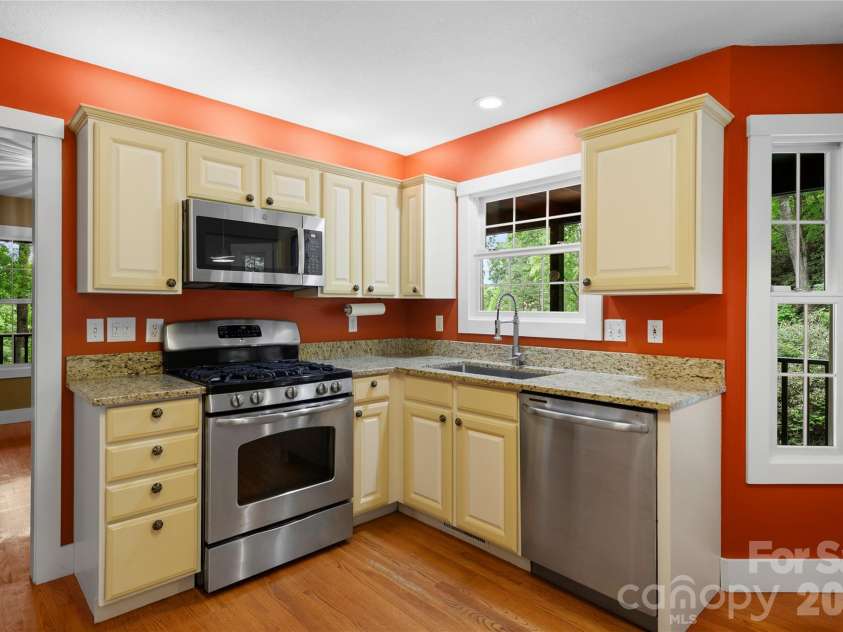 236 Holland Drive, Black Mountain, NC 28711.  MLS# CAR4412802, YatesRealty ID 45307. This spacious kitchen is filled with natural light and features a gas range, making it the perfect space for preparing meals.