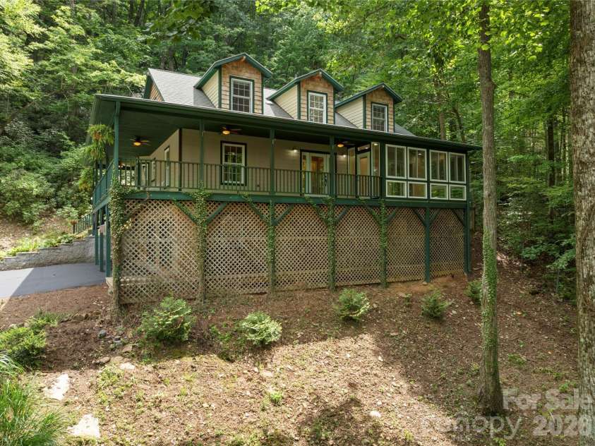 236 Holland Drive, Black Mountain, NC 28711.  MLS# CAR4412802, YatesRealty ID 45307. This well-designed home features thoughtful storage solutions throughout, including dedicated space for gardening tools and outdoor equipment tucked neatly beneath the latticed wrap-around porch.