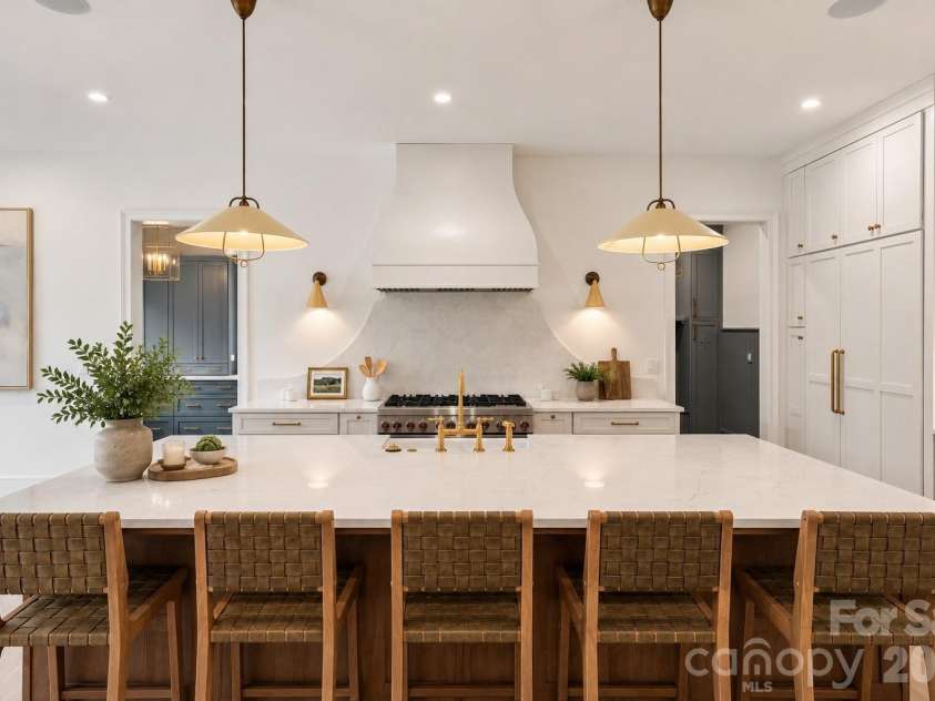 125 Randstone Court, Charlotte, NC 28211.  MLS# CAR4386565, YatesRealty ID 45343. Custom kitchen with oversized island, statement lighting and seamless access to the scullery and pantry