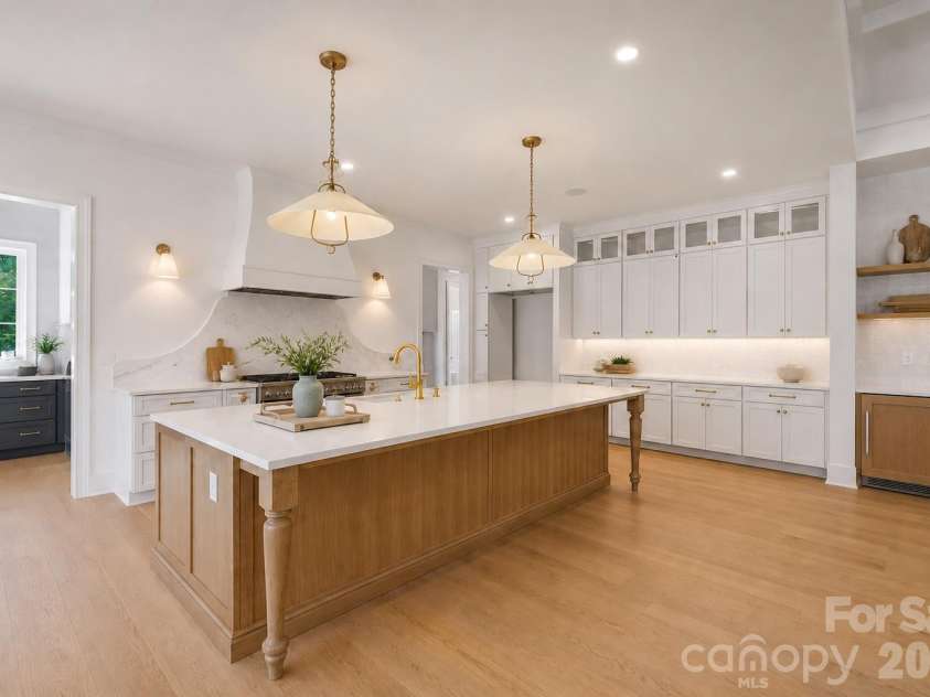 125 Randstone Court, Charlotte, NC 28211.  MLS# CAR4386565, YatesRealty ID 45343. Custom kitchen with oversized island, under cabinet & statement lighting w/ a hospitality bar for guest