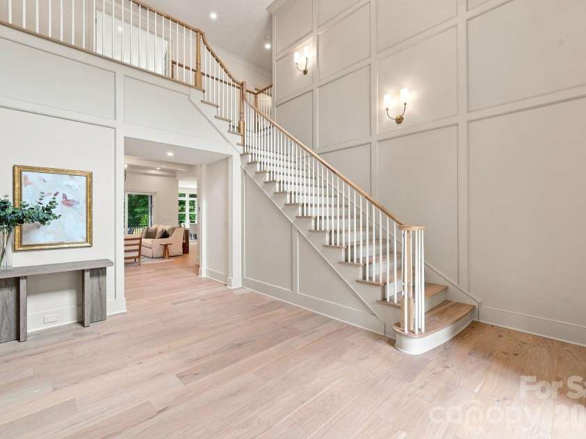 125 Randstone Court, Charlotte, NC 28211.  MLS# CAR4386565, YatesRealty ID 45343. Dramatic two-story foyer with custom panel molding and statement staircase.