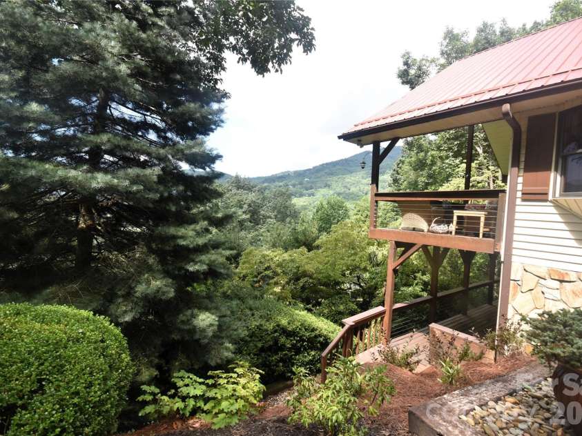 509 Deer Creek Trail, Maggie Valley, NC 28751.  MLS# CAR4408706, YatesRealty ID 45359. Lush landscaping and distant views