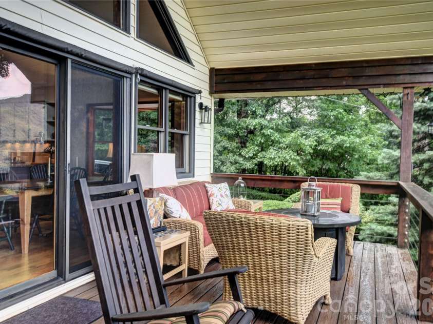 509 Deer Creek Trail, Maggie Valley, NC 28751.  MLS# CAR4408706, YatesRealty ID 45359. Seating area on the front deck