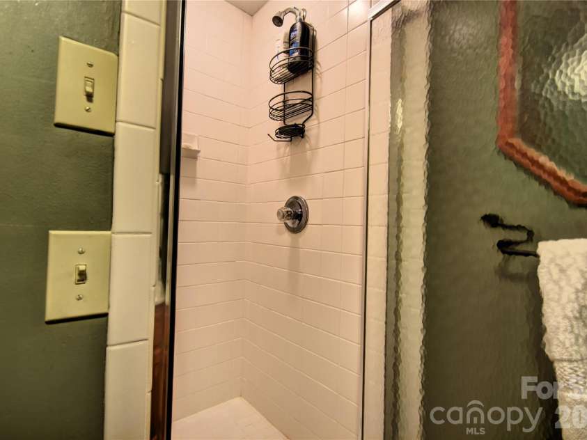 509 Deer Creek Trail, Maggie Valley, NC 28751.  MLS# CAR4408706, YatesRealty ID 45359. Shower in the upper-level bathroom