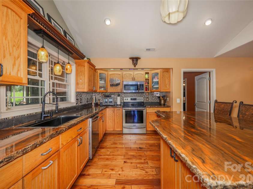 6851 Brantley Gordon Road, Denton, NC 27239.  MLS# CAR4409191, YatesRealty ID 45381. Kitchen with concrete countertops and tile backsplash