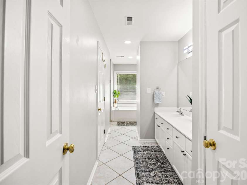 5933 Fitzwilliams Lane, Charlotte, NC 28270.  MLS# CAR4411055, YatesRealty ID 45409. Large primary bathroom includes linen closet.