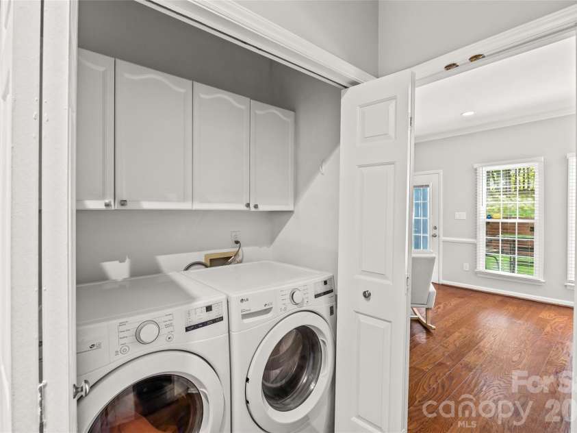 5933 Fitzwilliams Lane, Charlotte, NC 28270.  MLS# CAR4411055, YatesRealty ID 45409. Laundry area with cabinets.