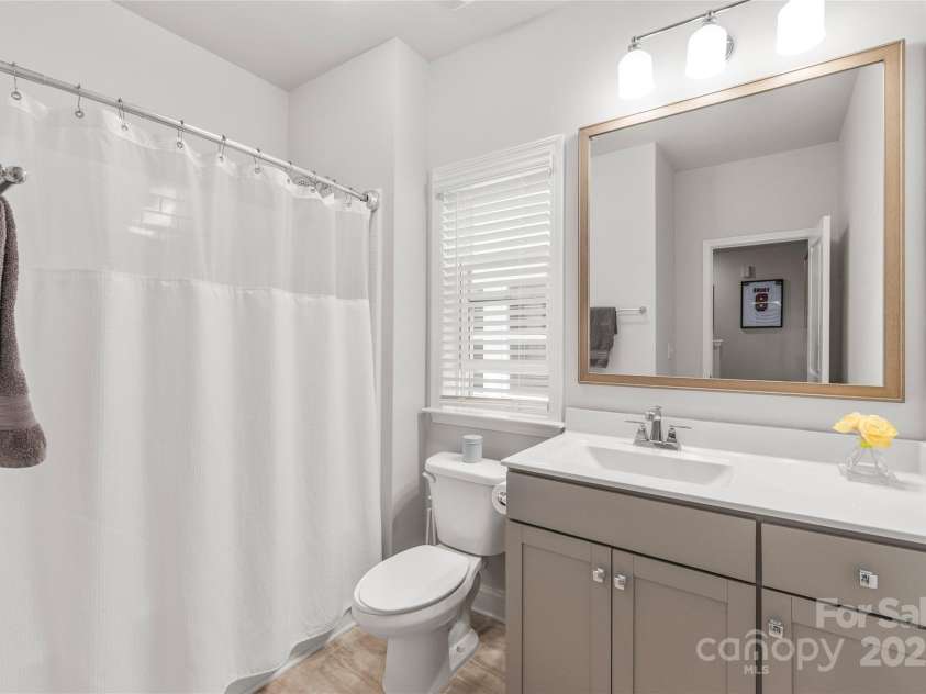 411 Belton Street, Charlotte, NC 28209.  MLS# CAR4321222, YatesRealty ID 4543. A full bathroom conveniently serves Bedrooms 3 and 4, offering comfort and functionality.