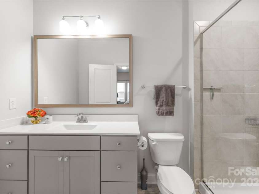 411 Belton Street, Charlotte, NC 28209.  MLS# CAR4321222, YatesRealty ID 4543. Bedroom 2 includes a full bathroom with a shower, providing privacy and convenience.