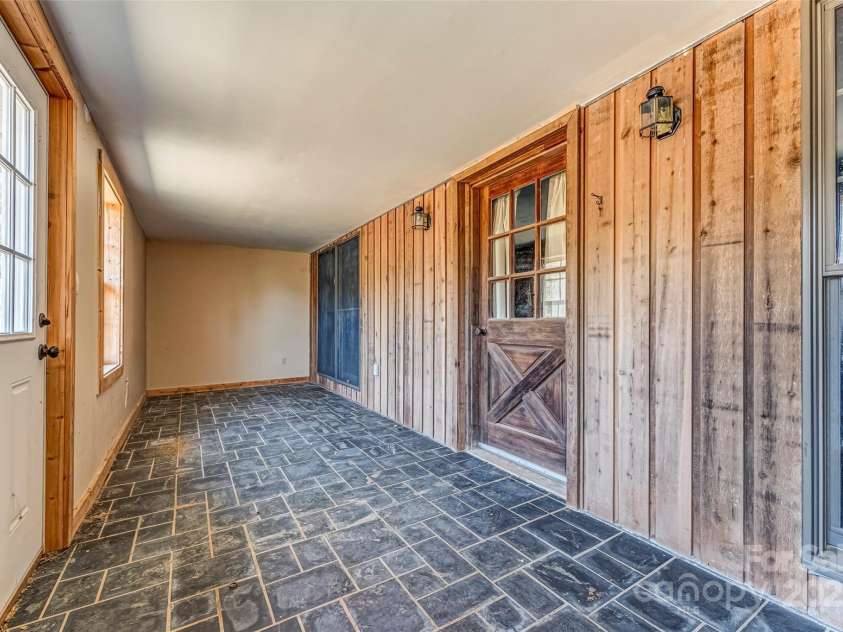 674 Walnut Ridge Road, Brevard, NC 28712.  MLS# CAR4235374, YatesRealty ID 4544. Barn Apartment - Main Level - Enclosed Porch