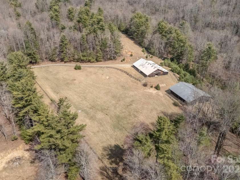 674 Walnut Ridge Road, Brevard, NC 28712.  MLS# CAR4235374, YatesRealty ID 4544. Drone Aerial of Pasture, Barn, and Riding Arena