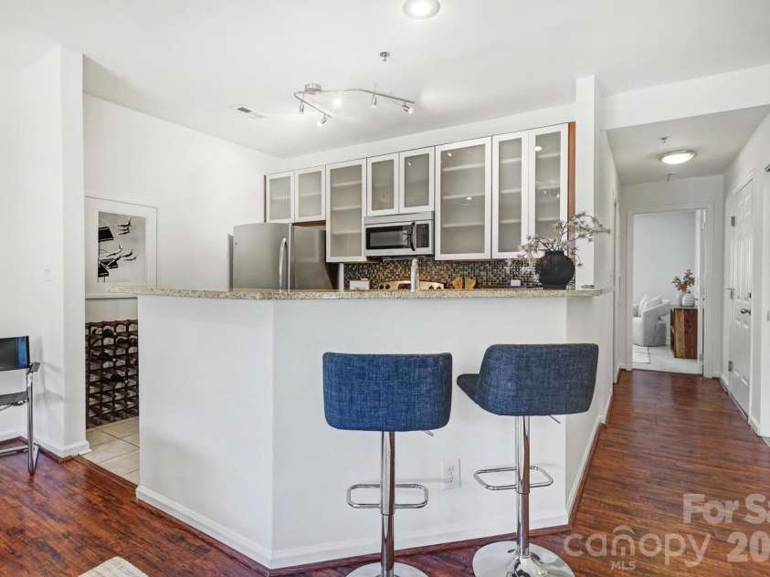 525 Graham Street, Charlotte, NC 28202.  MLS# CAR4341824, YatesRealty ID 4546. Breakfast bar seating integrated into the main living area for smart use of space.